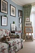 Floral sofa and framed artwork in London living room  England  UK
