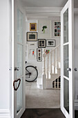 View through double doors to picture wall in hallway of South London Victorian terraced house