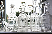 Cut glass vintage decanters on window sill in Norfolk coastguards cottage  England  UK