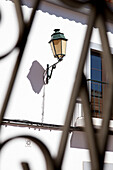 Vintage street lantern on white building exterior in Castro Marim, Portugal