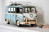 Light blue campervan with surfboards and gemstones on shelf in Amberley home, West Sussex, England, UK