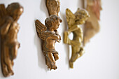 Decorative cherubs wall-mounted in Brighton home East Sussex England UK