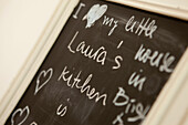 Handwriting on blackboard in Brighton kitchen, East Sussex, England, UK
