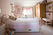 Wooden wardrobe and toys in girls room Amberley cottage West Sussex UK