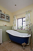 Freestanding bath at window of Amberley cottage West Sussex UK