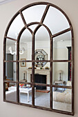 Arched vintage mirror with reflection of living room in Petworth farmhouse West Sussex Kent