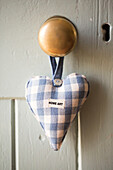 Blue checked heart on door handle in Petworth farmhouse West Sussex Kent