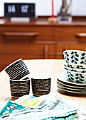 Retro style cups and bowls on dining table in London family home  England  UK