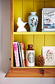 Ornaments and books in wall mounted shelving unit  Birmingham home  England  UK