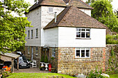 Car parked at exterior of detached weatherboard and stone house  United Kingdom