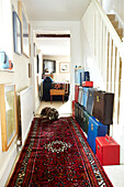 Multicoloured collection of attache cases in hallway of Brabourne farmhouse,  Kent,  UK