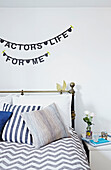 'An actors life for me' bunting above bed in Faversham home,  Kent,  UK