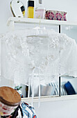 Lace collar on padded clothes hanger with mirror in bedroom of Faversham home,  Kent,  UK