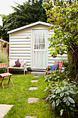 Deck chairs outside garden shed in back garden of Faversham home,  Kent,  UK
