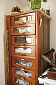 Wooden storage cabinet in work studio of Faversham home,  Kent,  UK