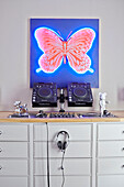 Butterfly canvas above mixing desk in London townhouse  England  UK