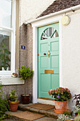 Light green front door with brass letterbox and knocker in Alloa  Scotland  UK