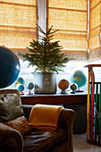 Christmas tree on windowsill with collection of globes in Rochester home  Kent  UK