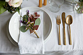 Cut flowers on place setting in London home  UK
