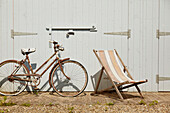Bicycle and deckchair outside residential garage in East Riding of Yorkshire  England  UK