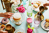 Women preparing table for afternoon tea in York home  England  UK