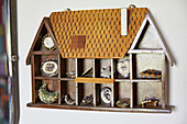 Vintage jewellery storage in wall mounted dolls house in York home  England  UK