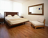 Double bedroom with laminate flooring and modern bedroom furniture