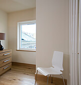 White chair and chest of drawers on landing