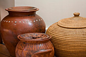 Earthenware pots and natural fibre basket in New Malden home, Surrey, England, UK