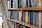 CD collection on wooden shelves in watermill conversion