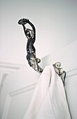 Art Nouveau figurative iron clothes hook on bathroom door
