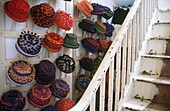 Wall display in stairwell of felt hats