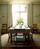 Breakfast room in country classical style with large pine table 