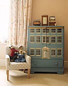Large blue doll's house in child's bedroom
