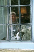 Window reflection of woman with her dog