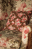 Printed flowery upholstered armchair and cushion