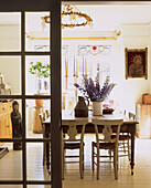 Country style dining room seen through the glazed doors of the sitting room