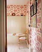 Vintage bathroom with wallpaper and wood panels