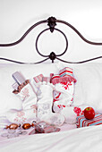 Festive christmas stockings lying on a bed filled with wrapped presents chocolate money and sweets