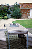 Slatted wooden patio furniture in Suffolk garden