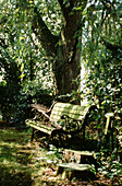 Rake on bench seat in Suffolk garden