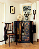 Lacquered cabinet and chair in room corner