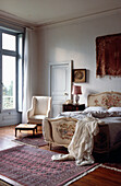 Embroidered head and footboards in French apartment bedroom