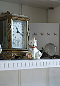 Close up of dresser with a clock and crystal apples from Vienna and a Polish glass tree decoration in the shape of a dog