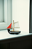 Model boat on bathroom windowsill