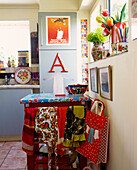 Kitchen trolley with strawberry print pvc and brightly coloured vintage fabrics in 1950s style kitchen