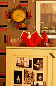Hand-painted wall with 1950s textile design clock and painted cupboard with postcards