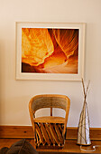 Wooden chair under photograph of canyon walls