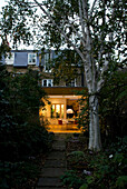 Path and tree leading to London kitchen extension