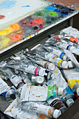 Tubes of oil paints and mixing palette